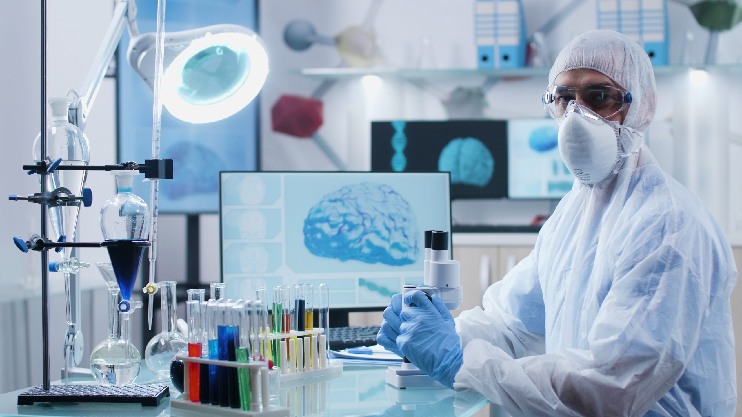 Portrait of specialist doctor with ppe equipment analyzing dna sample working at illness diagnosis