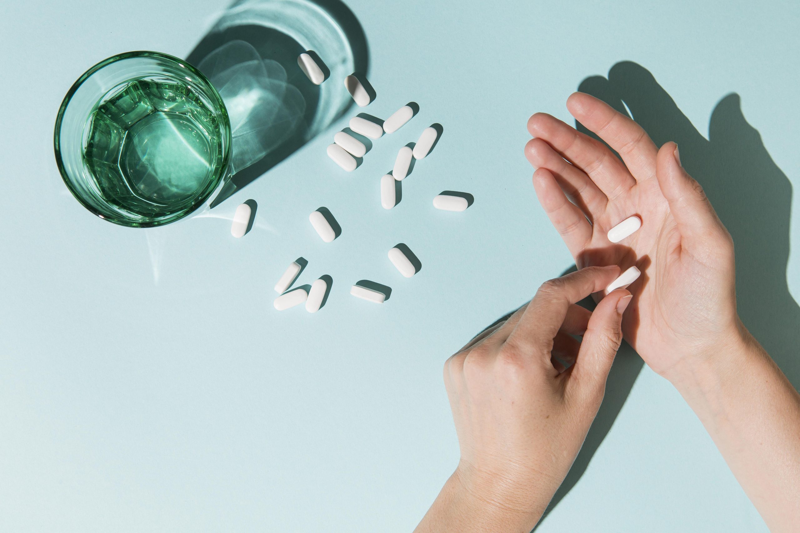 top-view-medicine-with-water-glass-table