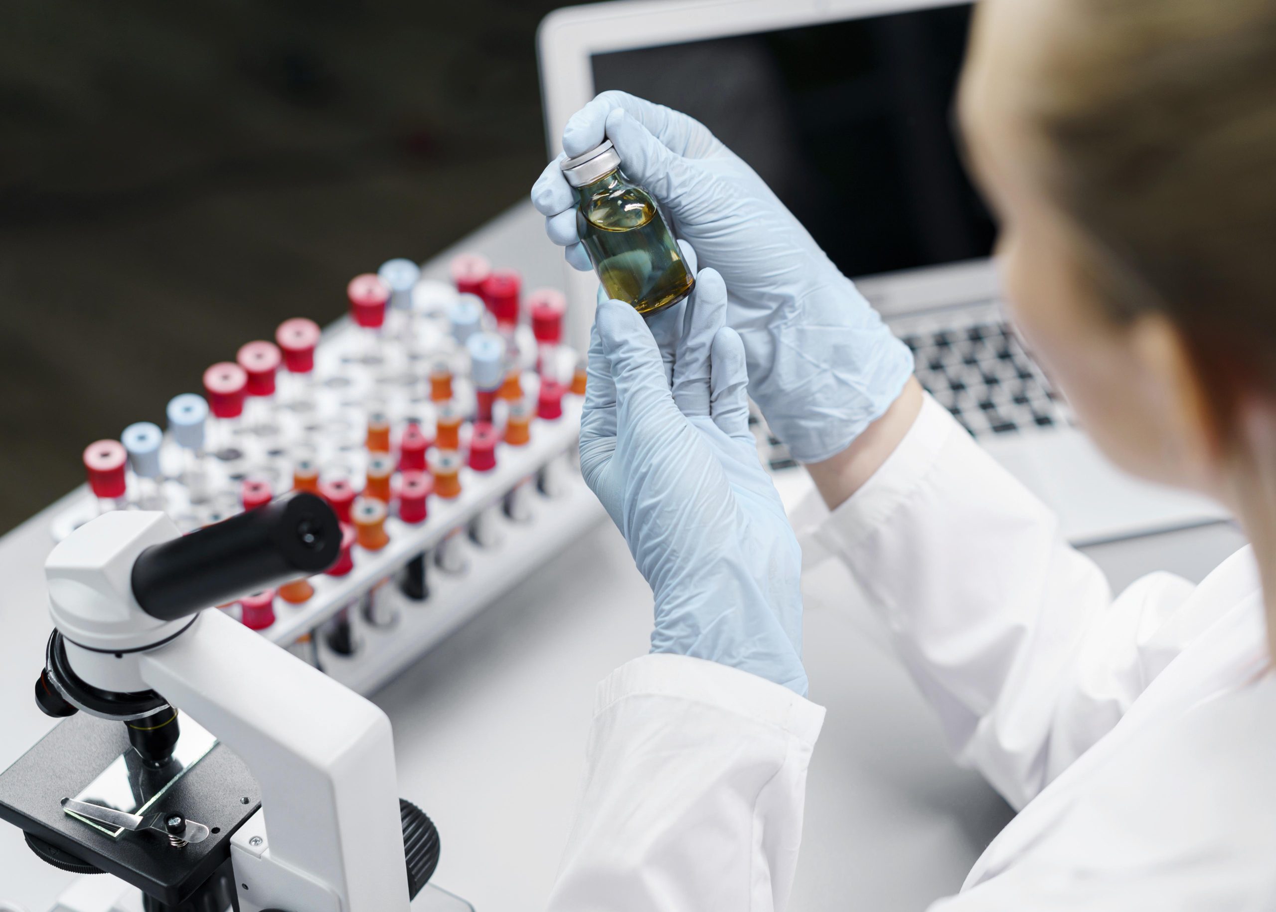 female-researcher-laboratory-with-test-tubes-vaccine-bottle