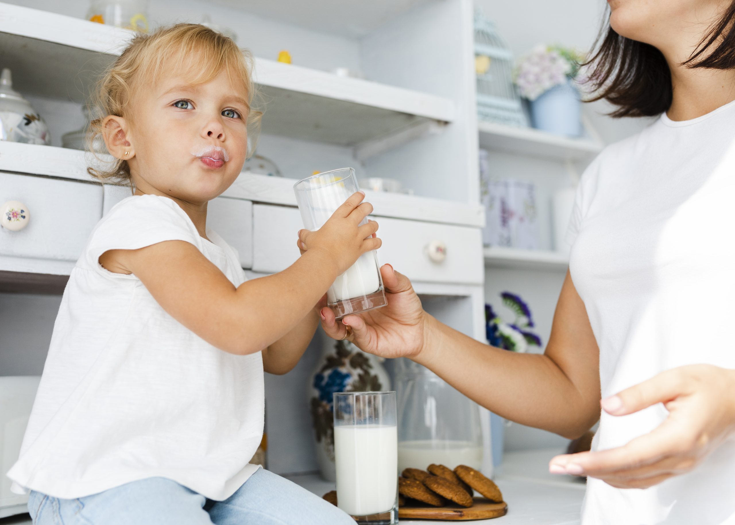 funny-little-girl-holding-glass-milk
