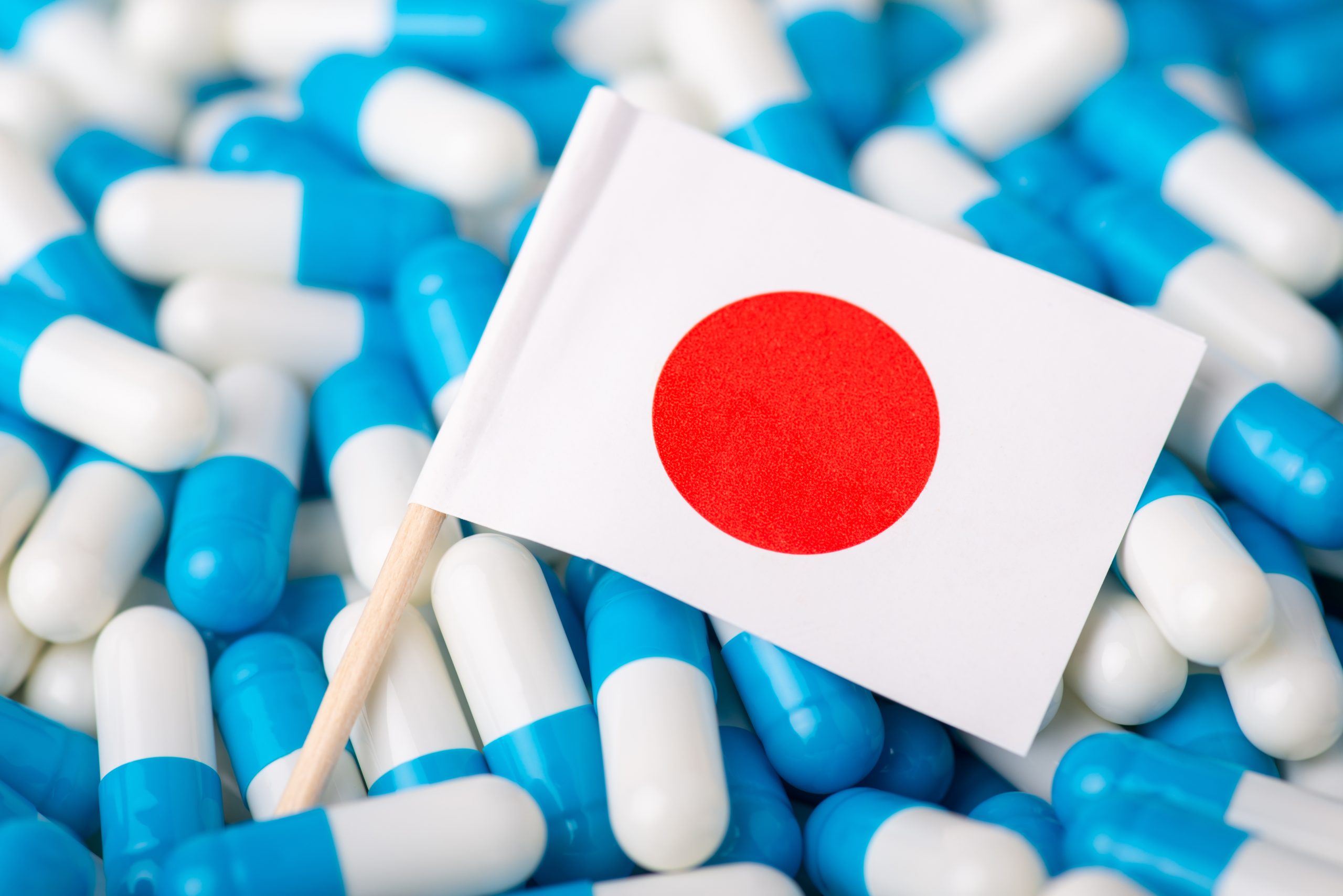 Medicine in Japan. Flag of Japan in blue and white pills