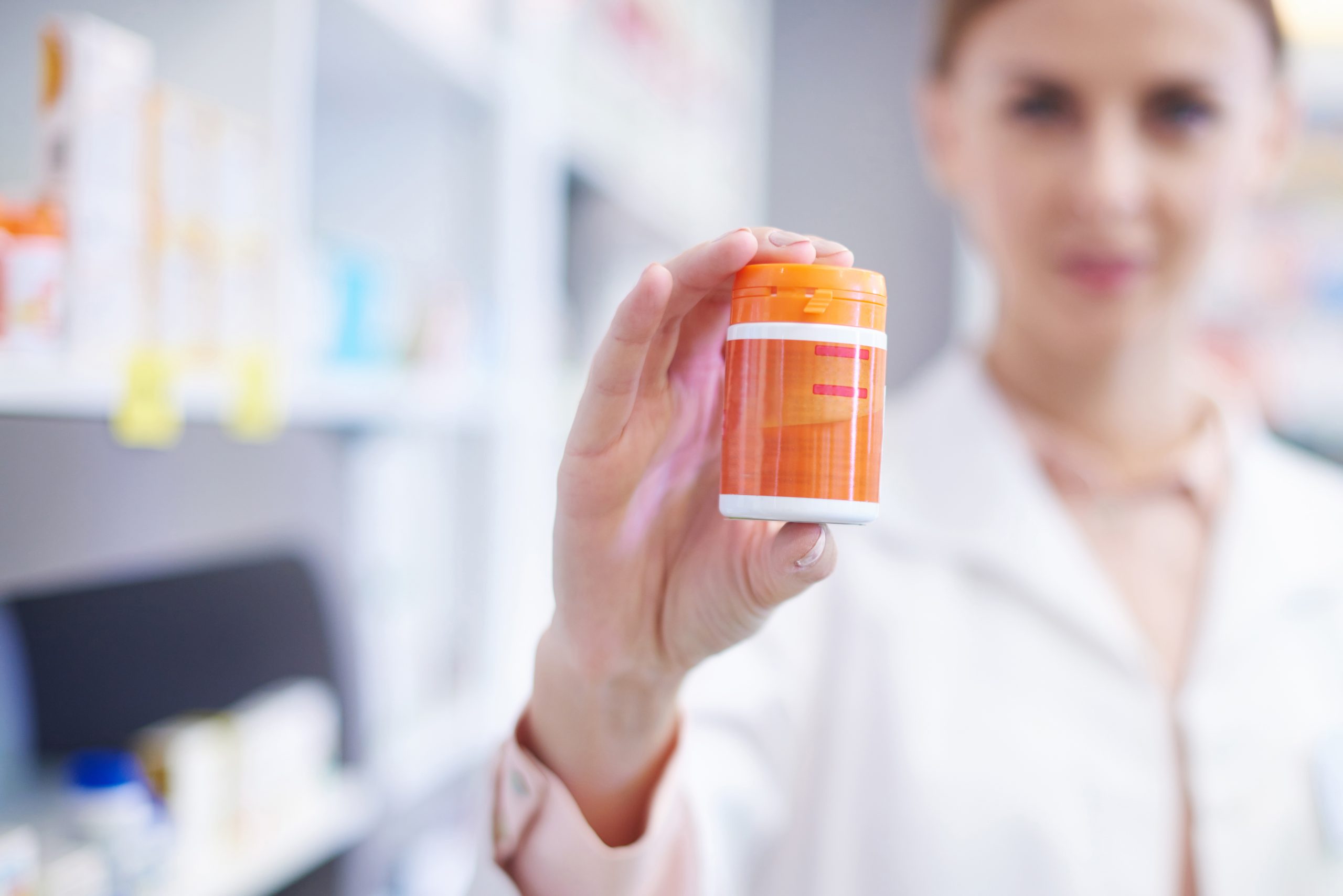 Pharmacist with bottle of pills