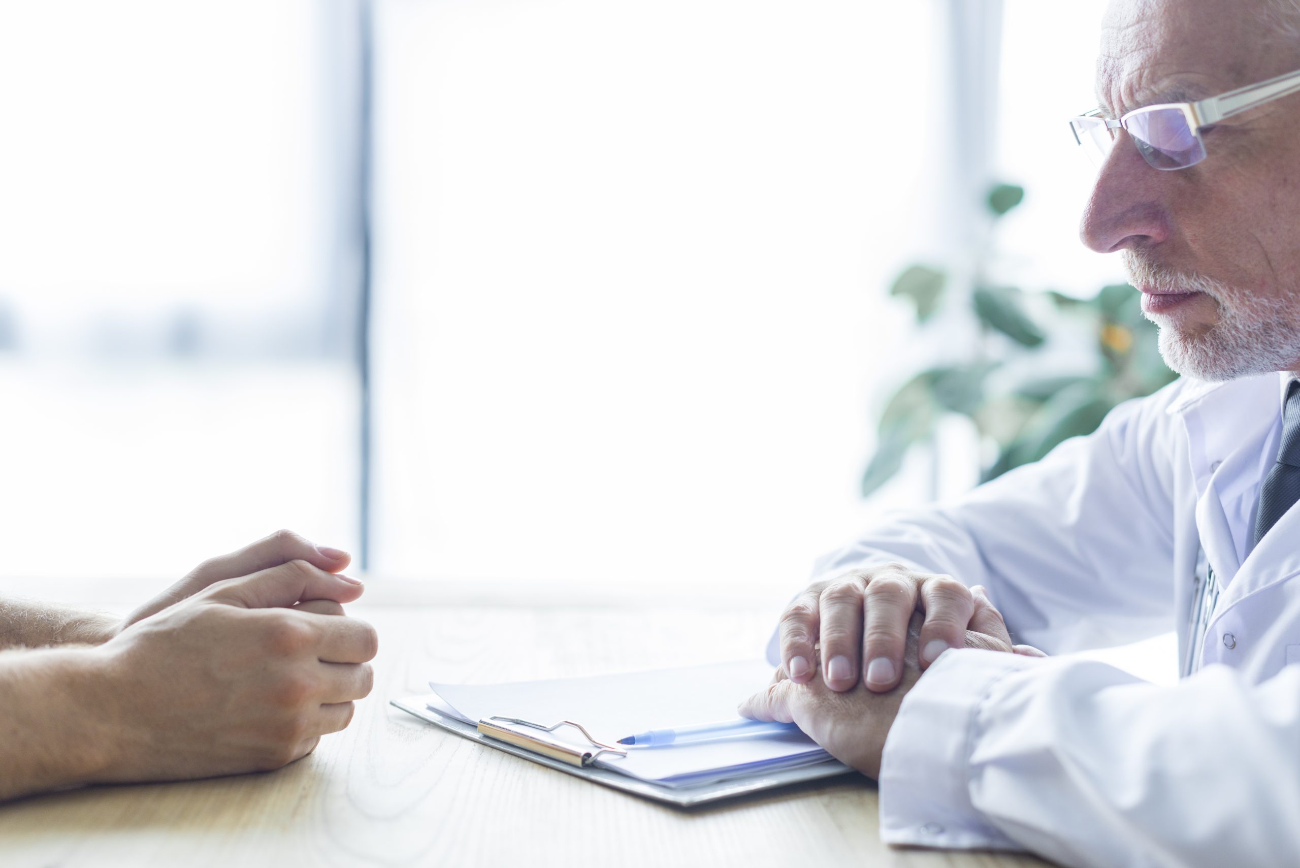elderly-doctor-with-patient-office